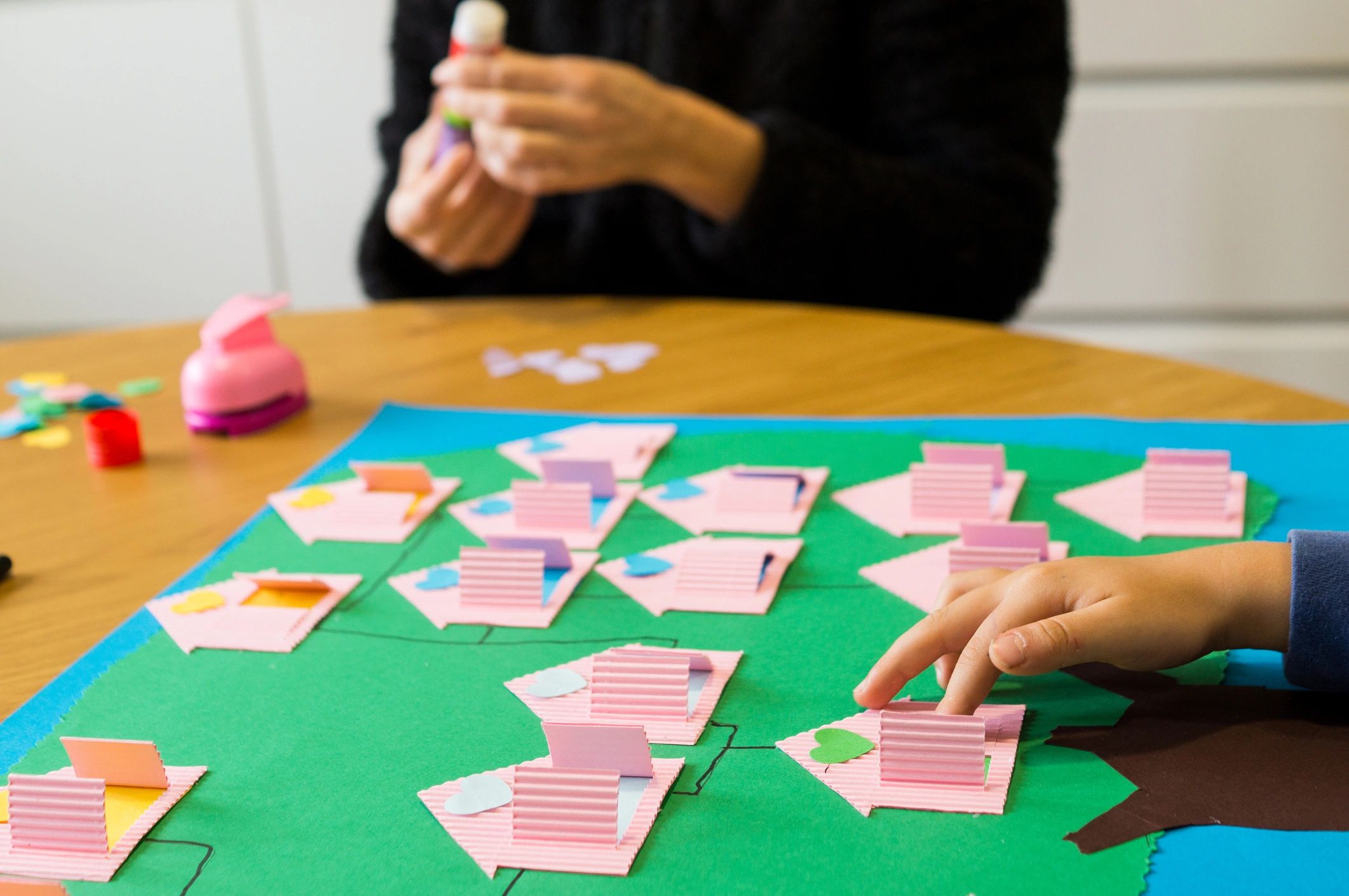 People gathered around a craft table during a creative stationery event
